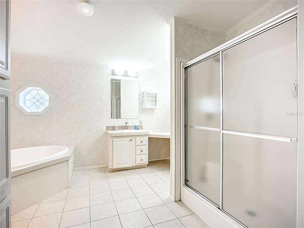 8307 Nancy Lane Ellenton, FL 34222 - Photo 17 of 56 a bathroom with a granite countertop sink mirror vanity and toilet