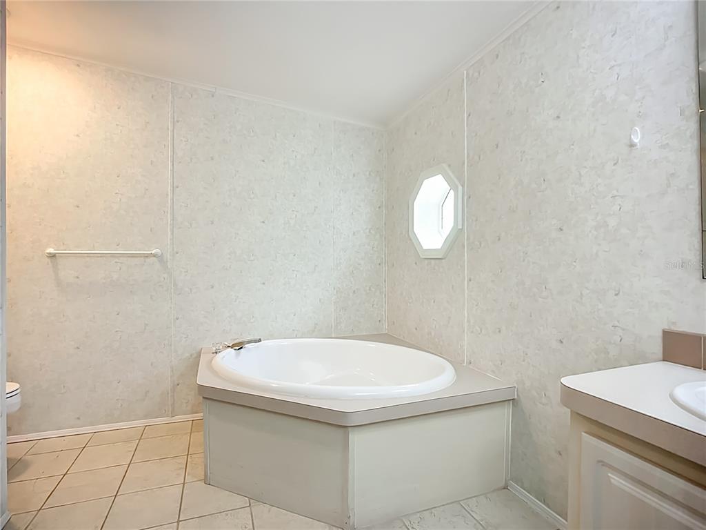 8307 Nancy Lane Ellenton, FL 34222 - Photo 18 of 56 a bathroom with a sink a toilet and mirror