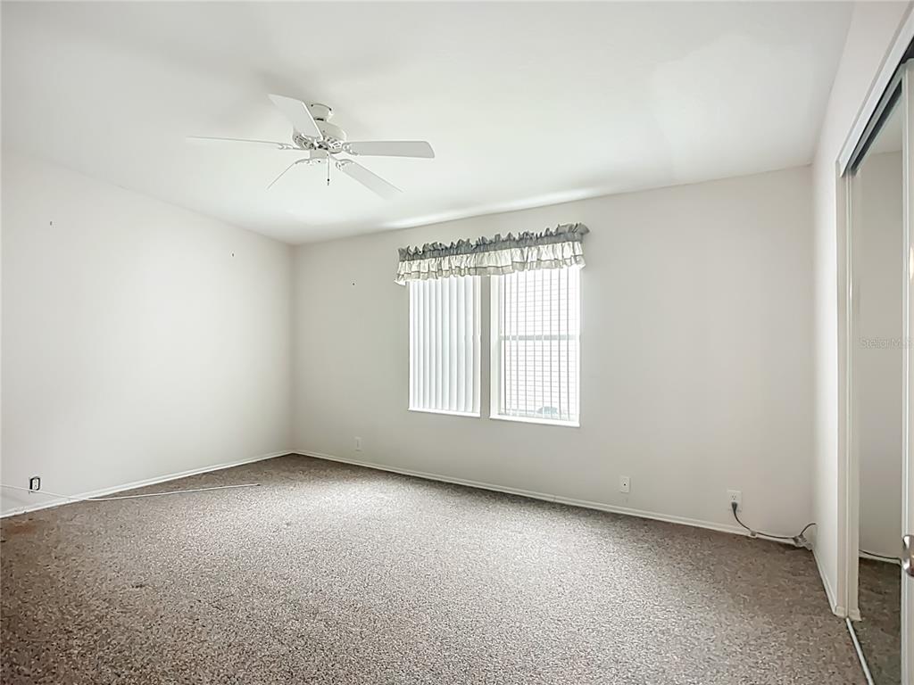 8307 Nancy Lane Ellenton, FL 34222 - Photo 20 of 56 an empty room with a window and a fan