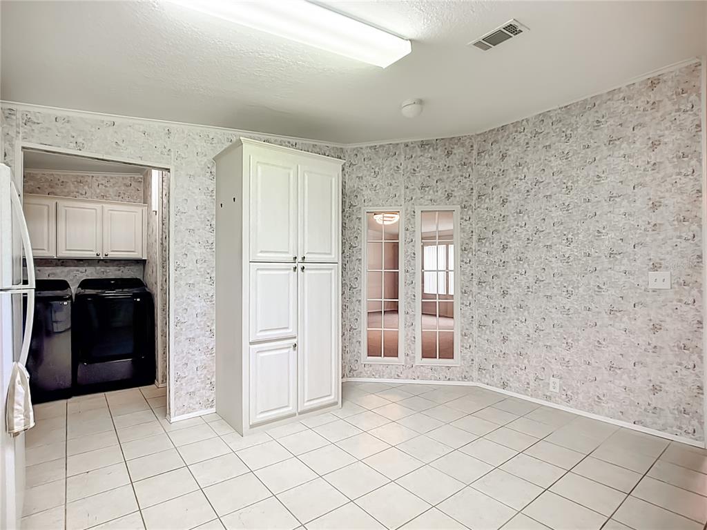 8307 Nancy Lane Ellenton, FL 34222 - Photo 4 of 56 a view of a refrigerator in kitchen and an empty room