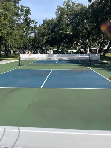 a view of a green field with sitting area