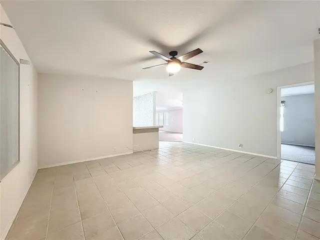 an empty room with a empty space and a ceiling fan window