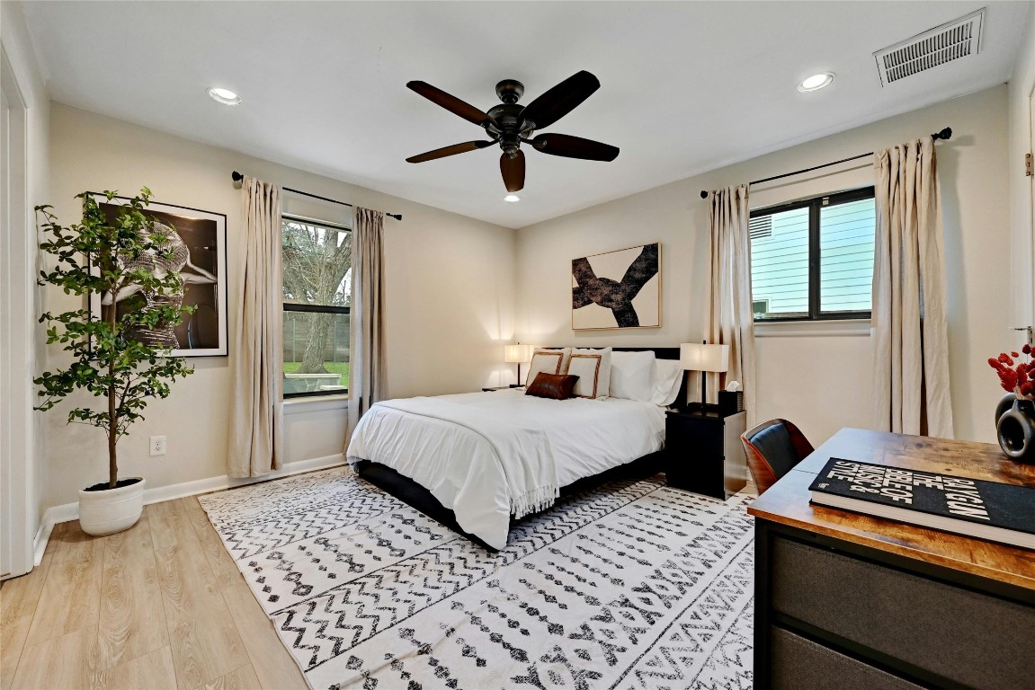 2511 Friar Tuck Lane Austin, TX 78704 - Photo 11 of 21 a bedroom with a large bed and a chandelier