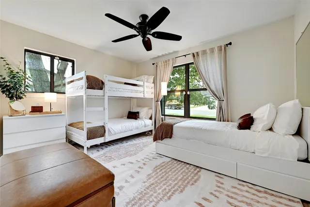 a living room with a bed furniture and a large window