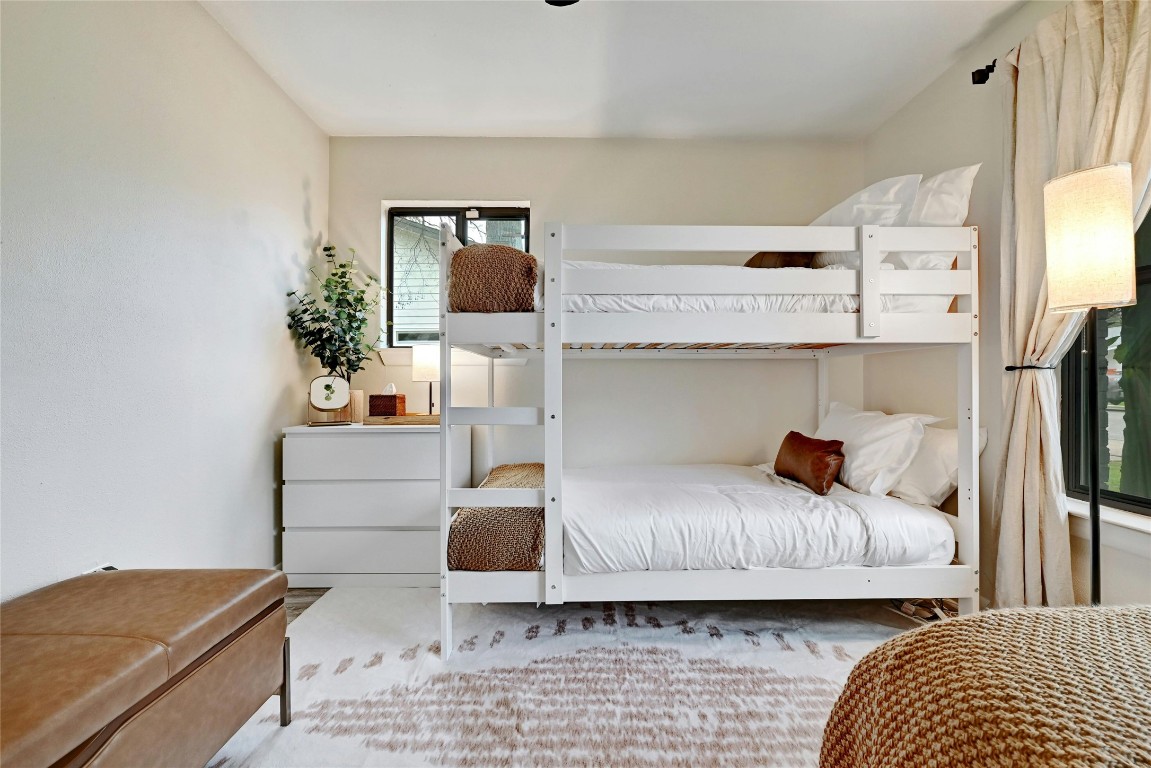 2511 Friar Tuck Lane Austin, TX 78704 - Photo 17 of 21 a bedroom with a bed and a flat screen tv