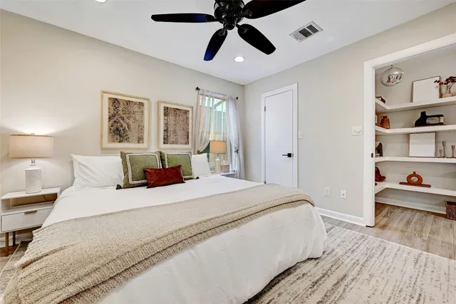 a bedroom with a large bed and a chandelier