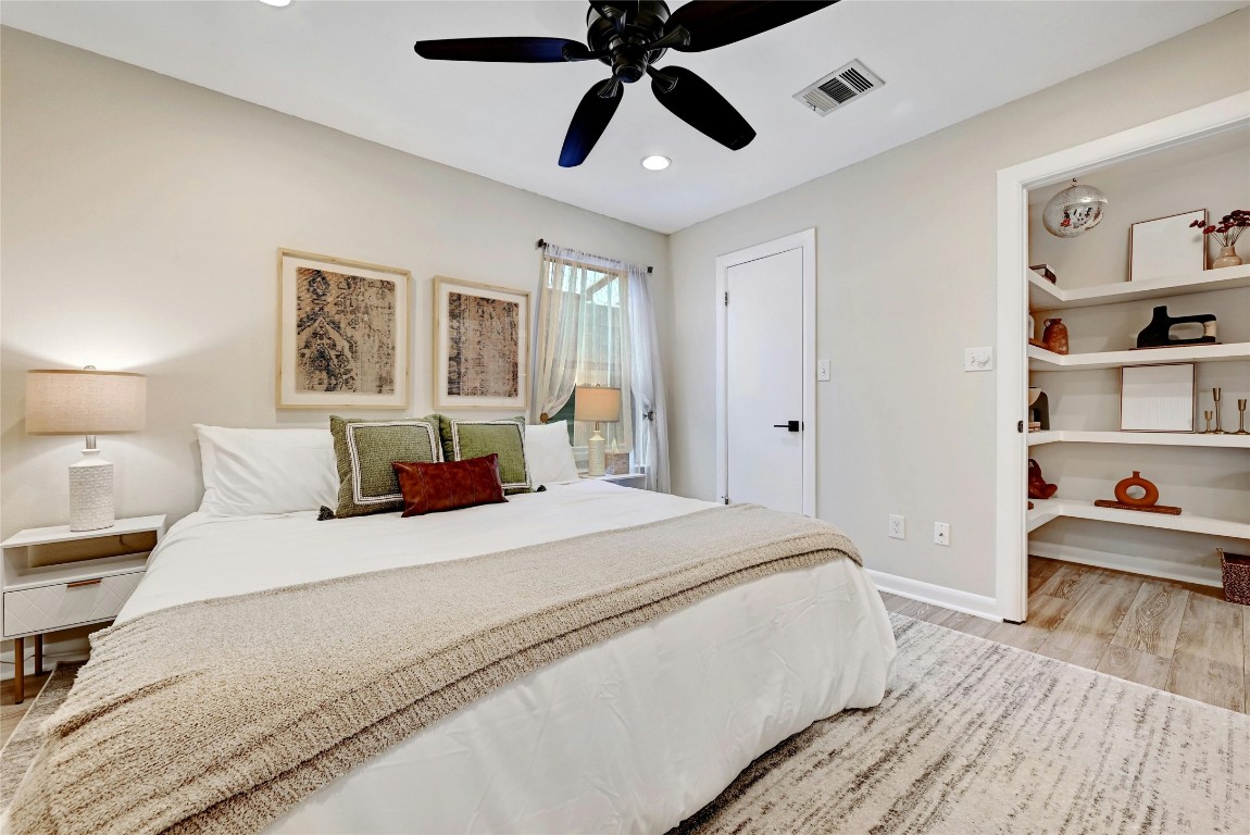 2511 Friar Tuck Lane Austin, TX 78704 - Photo 19 of 21 a bedroom with a large bed and a chandelier