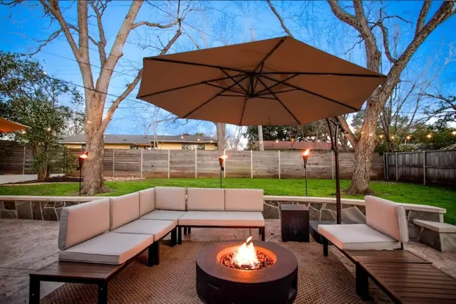 a view of a backyard with sitting area