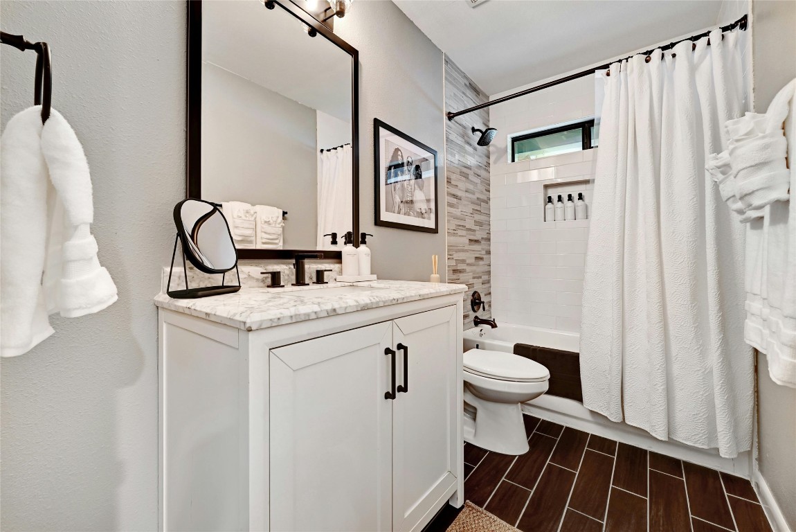 2511 Friar Tuck Lane Austin, TX 78704 - Photo 21 of 21 a bathroom with a sink a toilet and a mirror