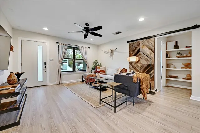 a living room with furniture or wooden floor and a window