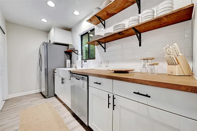 a kitchen with stainless steel appliances a refrigerator and cabinets