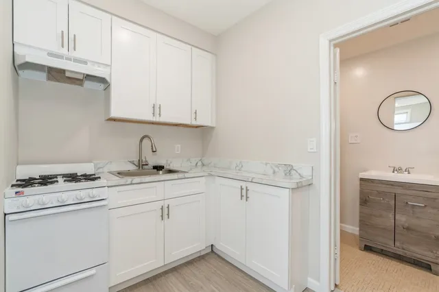 a kitchen with appliances cabinets and a sink