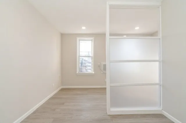 a view of a room with a refrigerator and window