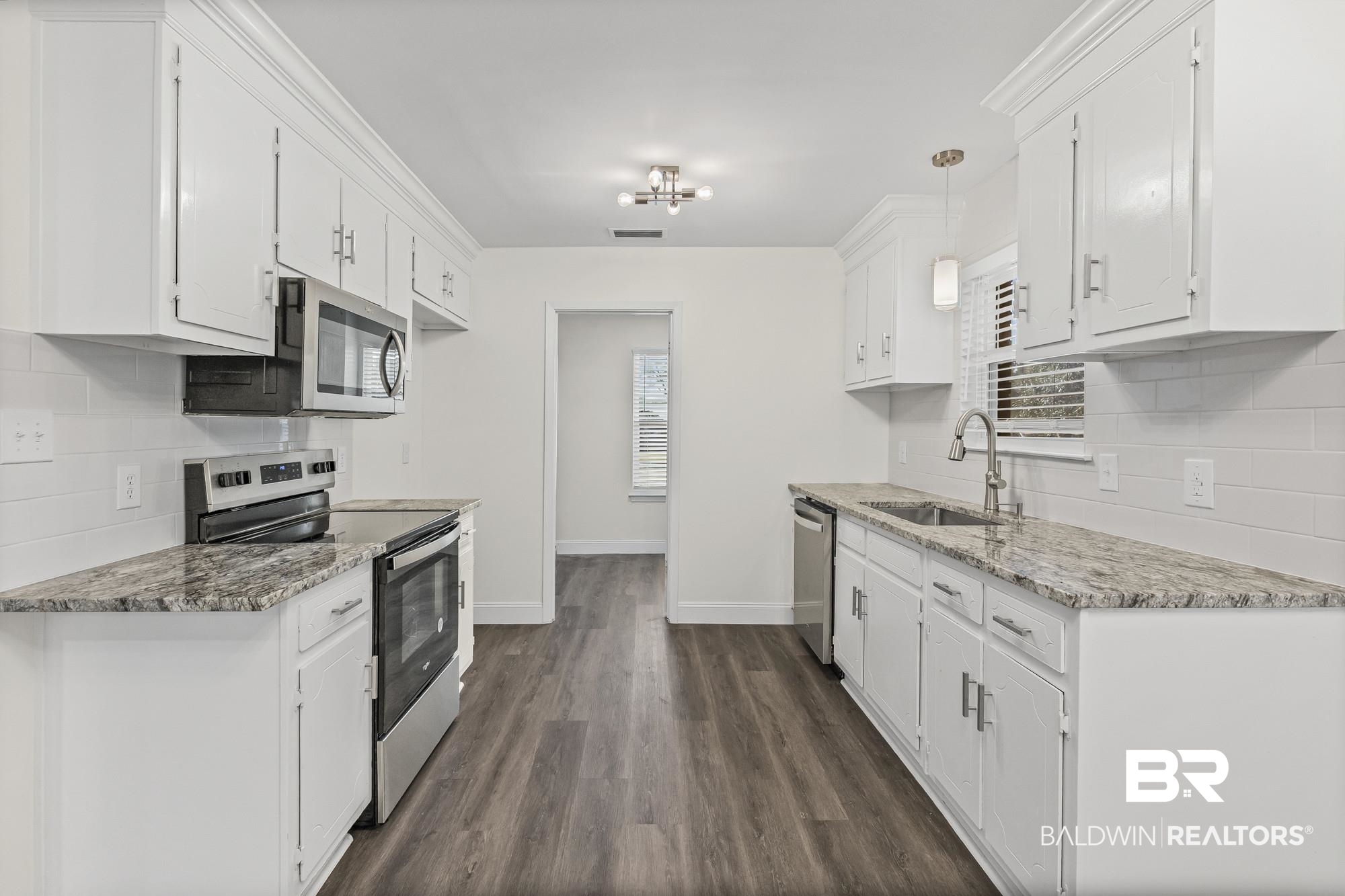 3041 Pretty Branch Drive East Mobile, AL 36618 - Photo 9 of 20 Kitchen featuring backsplash, appliances with stainless steel finishes, light stone counters, and pendant lighting