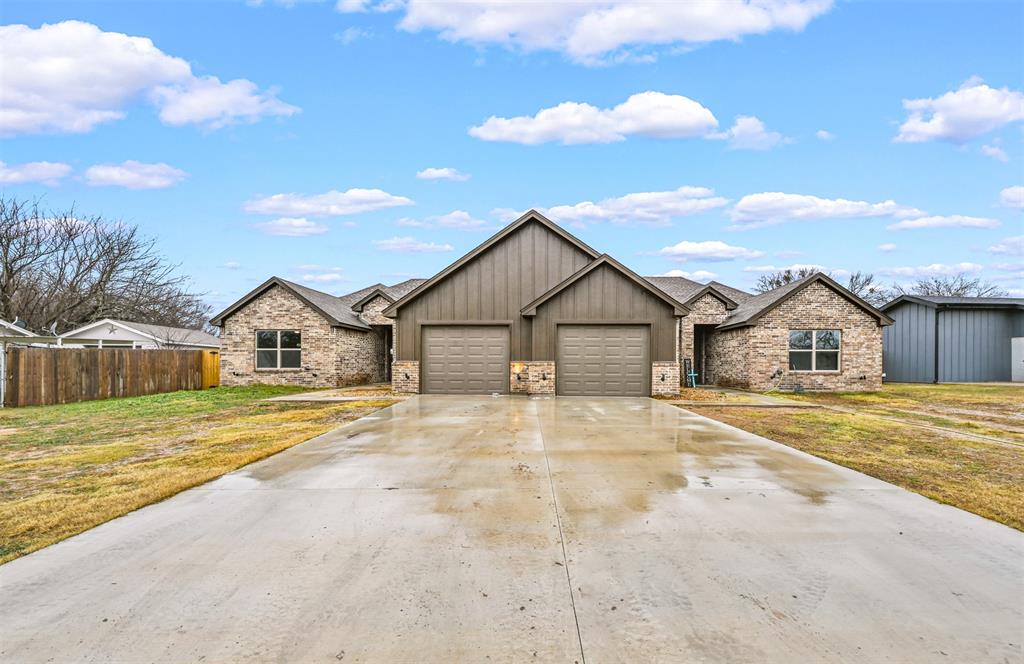 228 St Charles Drive, Unit B Springtown, TX 76082 - Photo 1 of 1 a front view of a house with a yard and garage