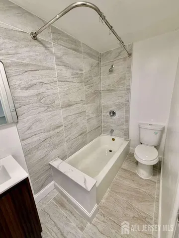 a bathroom with a toilet a sink and bathtub