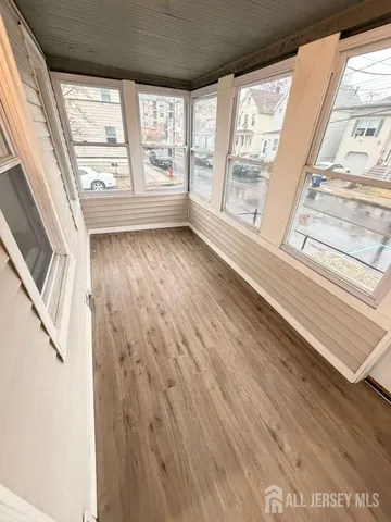 a view of an entryway with wooden floor
