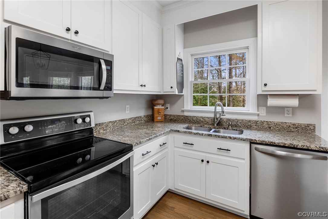 820 Club Ridge Court Chester, VA 23836 - Photo 10 of 38 a kitchen with granite countertop a stove microwave and sink