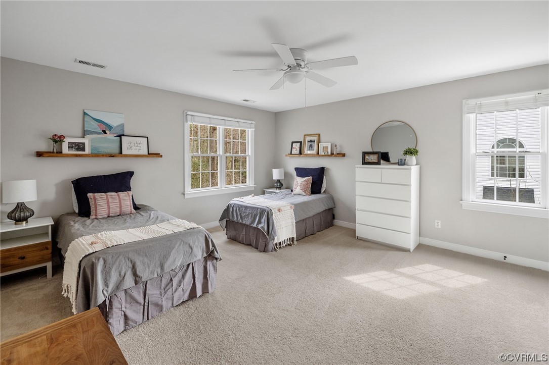 820 Club Ridge Court Chester, VA 23836 - Photo 21 of 38 a spacious bedroom with two beds and a chandelier