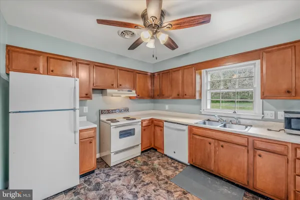 a kitchen with a sink stainless steel appliances and window