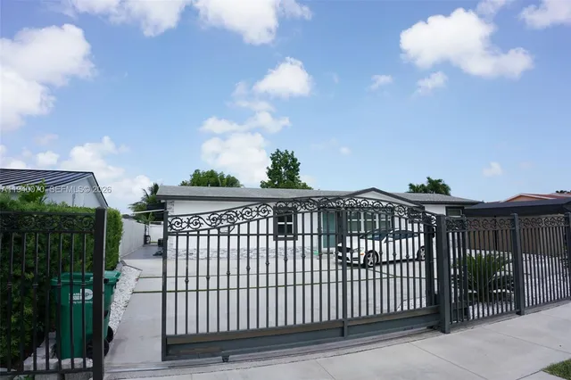 a view of a wrought iron fences in front of house
