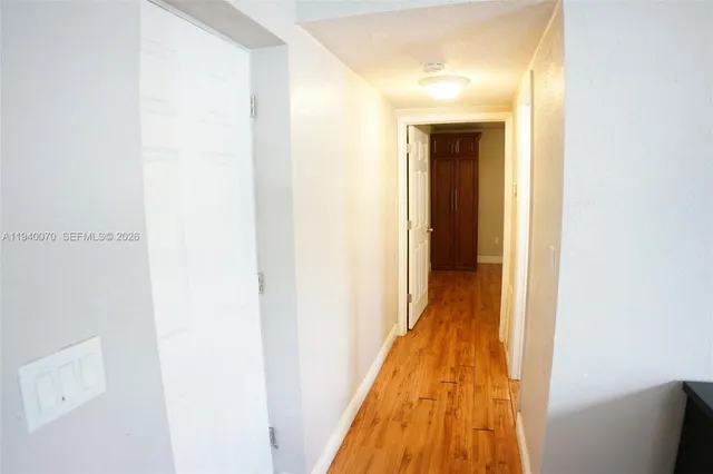 a view of a hallway with wooden floor