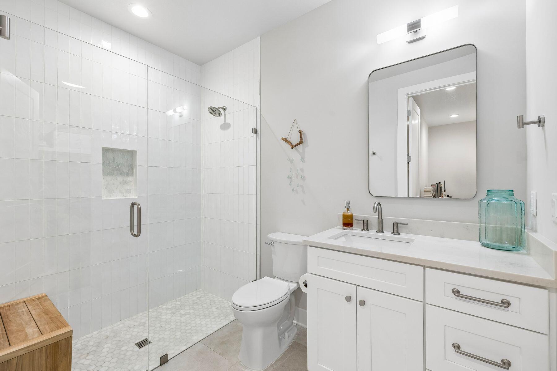 39 West Captain Fritz Way Freeport, FL 32439 - Photo 23 of 33 a bathroom with a sink toilet vanity and shower
