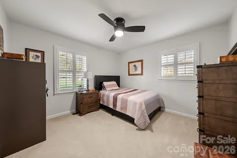 a spacious bedroom with a bed and a window