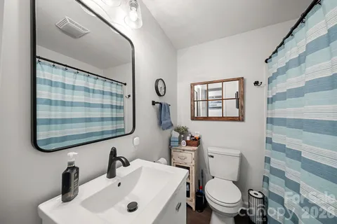 a bathroom with a toilet a sink and a mirror