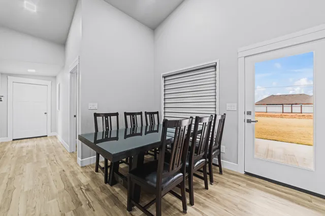 a view of a dining room with furniture and wooden floor