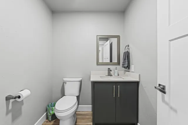 a bathroom with a toilet a sink and mirror