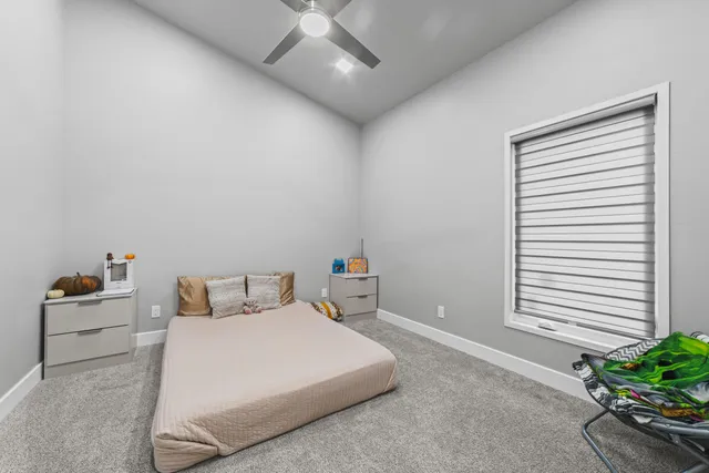 a bedroom with a bed and a potted plant