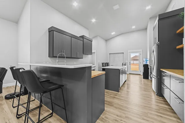 a kitchen with stainless steel appliances kitchen island granite countertop a sink and cabinets