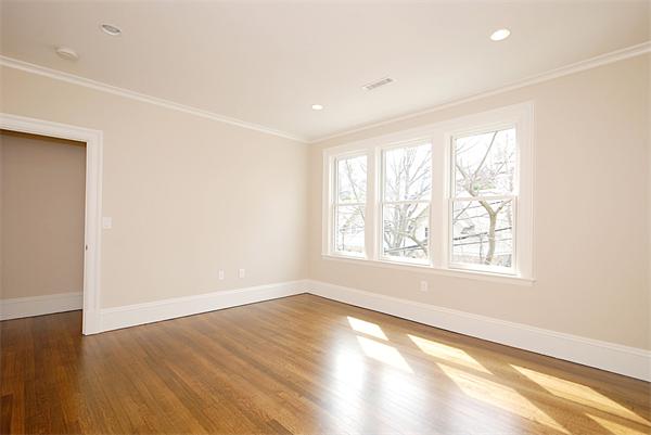 34 Rawson Road, Unit 2 Brookline, MA 02445 - Photo 12 of 24 an empty room with wooden floor and windows