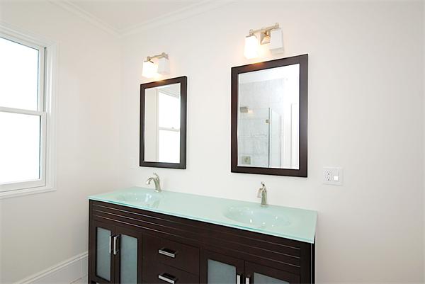 34 Rawson Road, Unit 2 Brookline, MA 02445 - Photo 13 of 24 a bathroom with a sink and a mirror