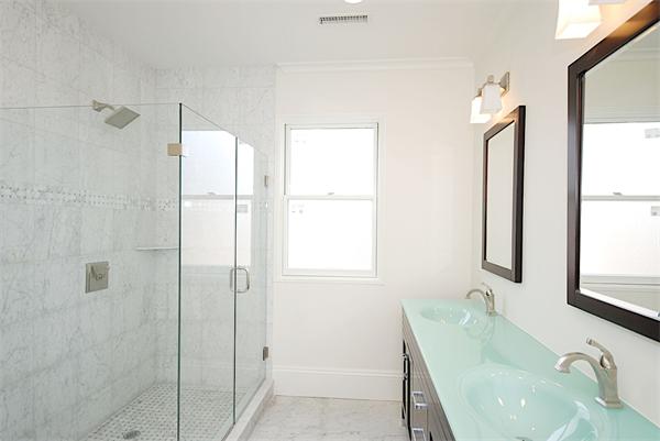 34 Rawson Road, Unit 2 Brookline, MA 02445 - Photo 14 of 24 a bathroom with a granite countertop sink mirror and window