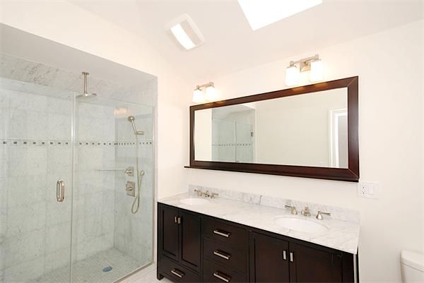 34 Rawson Road, Unit 2 Brookline, MA 02445 - Photo 19 of 24 a bathroom with a double vanity sink mirror and shower