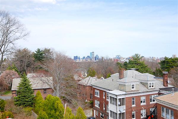 34 Rawson Road, Unit 2 Brookline, MA 02445 - Photo 20 of 24 a view of a white building among the middle of a city