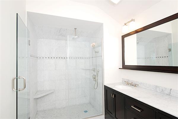 34 Rawson Road, Unit 2 Brookline, MA 02445 - Photo 21 of 24 a bathroom with a shower sink and mirror