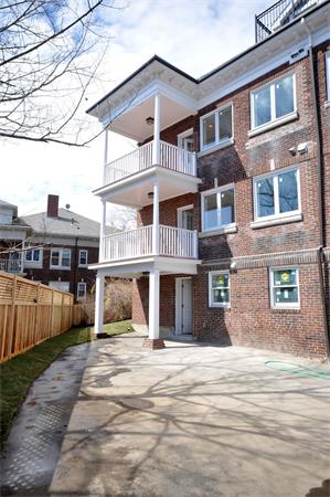 34 Rawson Road, Unit 2 Brookline, MA 02445 - Photo 22 of 24 a front view of a house with a yard