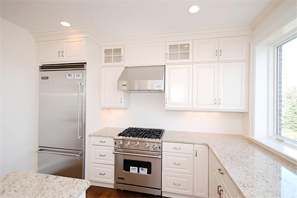 34 Rawson Road, Unit 2 Brookline, MA 02445 - Photo 4 of 24 a kitchen with cabinets and a refrigerator
