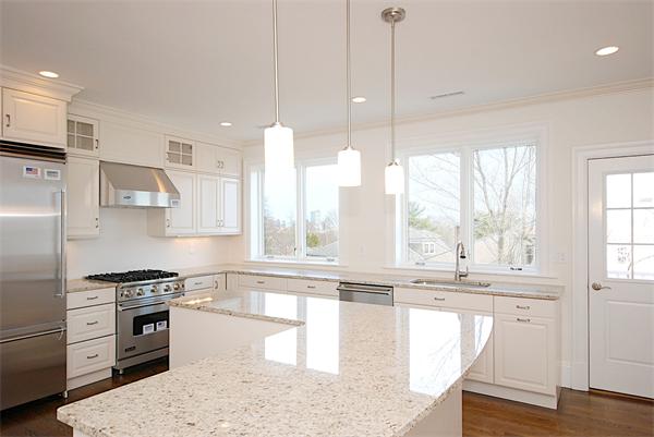 34 Rawson Road, Unit 2 Brookline, MA 02445 - Photo 5 of 24 a kitchen with stainless steel appliances granite countertop a stove a sink and a refrigerator with wooden floor