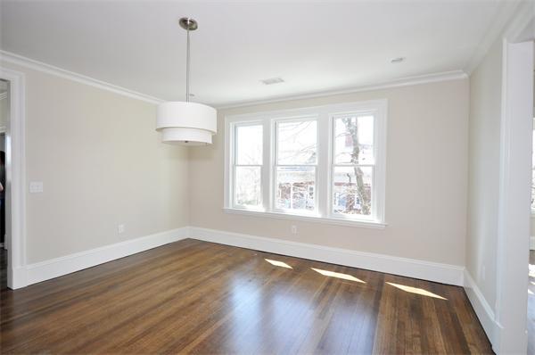 34 Rawson Road, Unit 2 Brookline, MA 02445 - Photo 8 of 24 a view of an empty room with wooden floor and a window