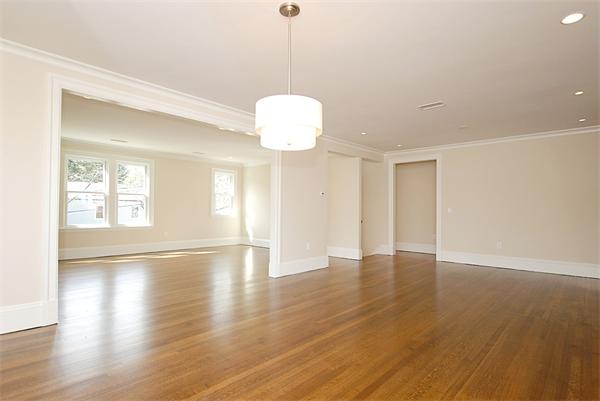 34 Rawson Road, Unit 2 Brookline, MA 02445 - Photo 9 of 24 a view of an empty room with wooden floor and windows