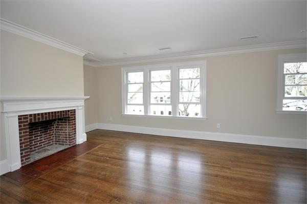 34 Rawson Road, Unit 2 Brookline, MA 02445 - Photo 10 of 24 an empty room with wooden floor fireplace and windows