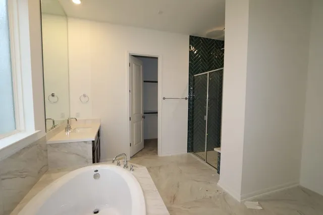a bathroom with a bathtub sink and mirror