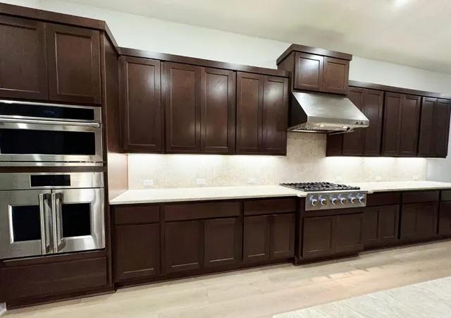 a kitchen with a sink stove and microwave
