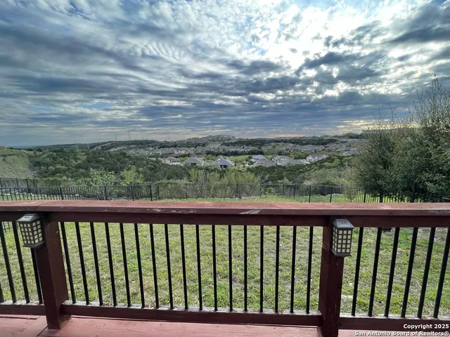 a view of a balcony with wooden floor and outdoor seating