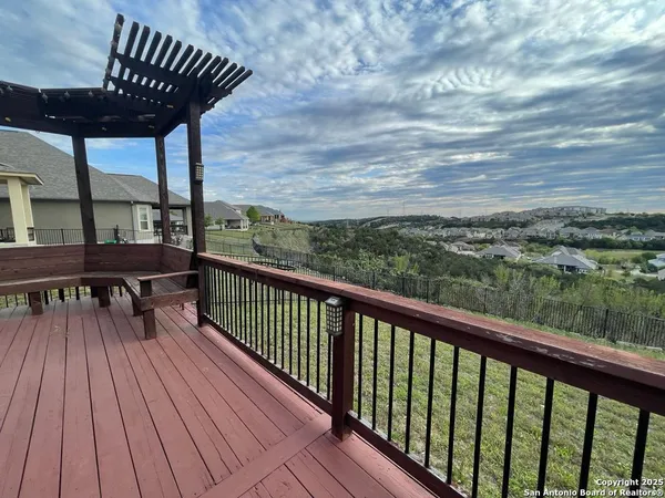a view of a house with a deck and a yard