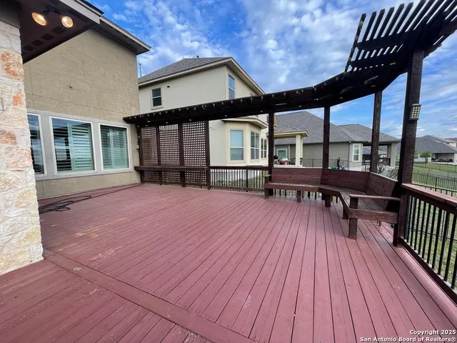 a view of balcony with wooden floor and fence